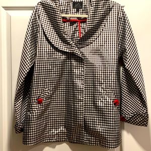 UBU black and white check rain jacket with red buttons.